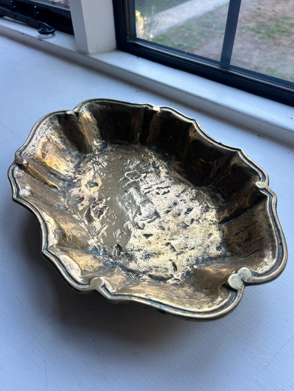 A heavy brass lobe shaped dish with incised initials & date 1700
